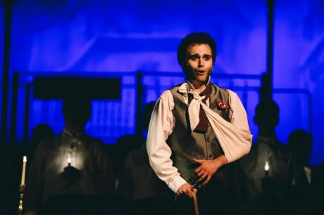 Henry Cyr (Marius) singing "Empty Chairs at Empty Tables." Photo by Kevin Gall.