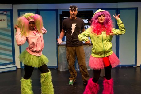 Shravan Amin as the Zapper looks on baffled as SuperPhenom PowerTwins DeAndriea Norman and Brittany Martz strut their stuff. Photo by Harvey Levine.