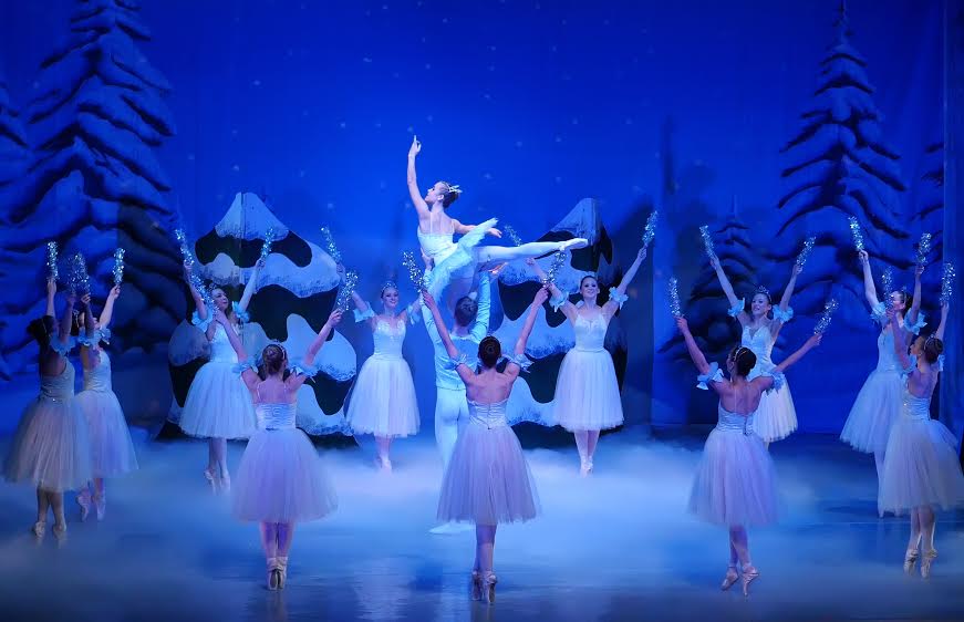 Snowflakes dance across the stage. Photo by Nick Eckert.